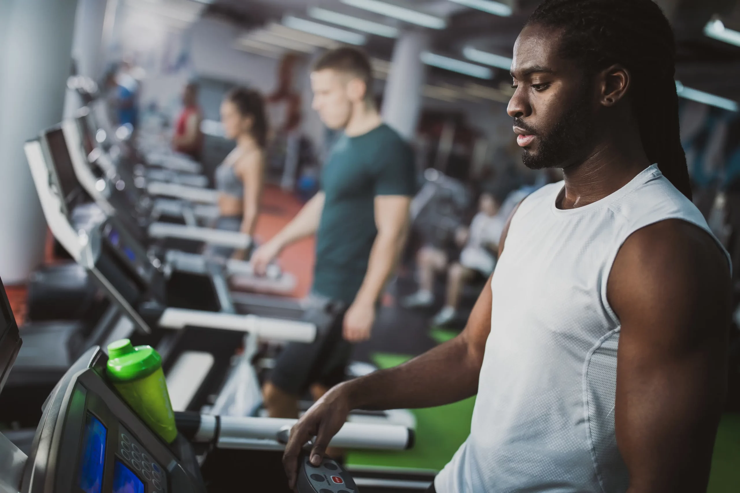 Natural Ways to Boost Testosterone and Support Healthy Weight Management Man exercising at the gym to support healthy testosterone levels and weight management