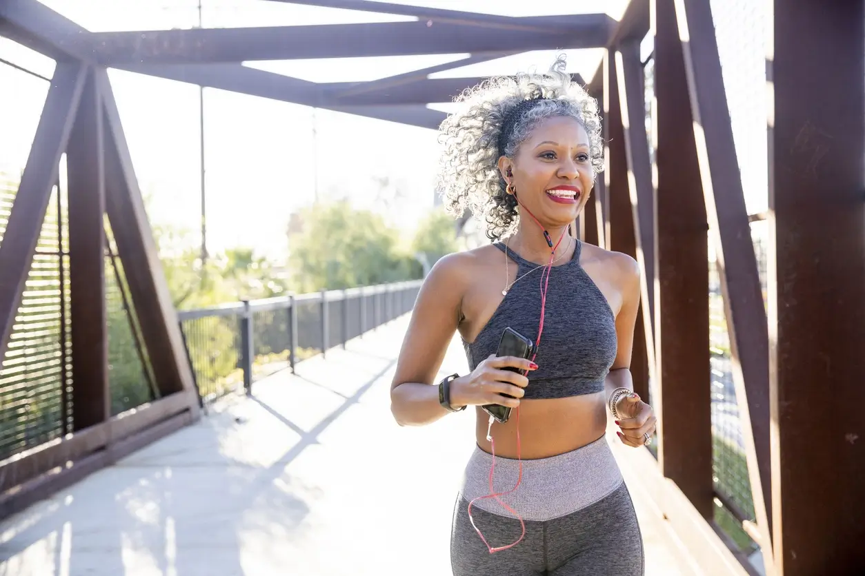 Active woman jogging outdoors, representing physical activity and wellness while learning about BPC-157