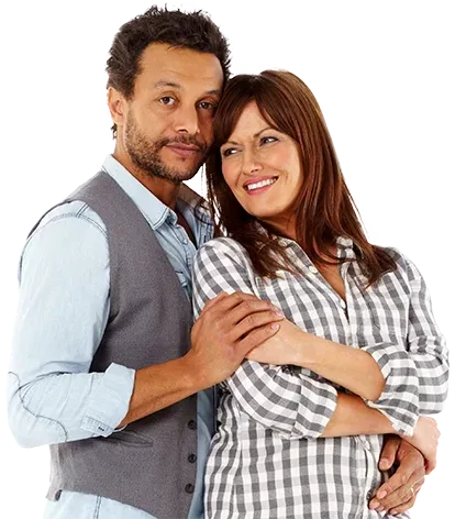 Smiling middle-aged couple embracing while learning about BPC-157 peptide therapy