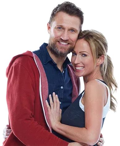 Smiling middle-aged couple embracing, representing intimacy, wellness, and healthy aging.