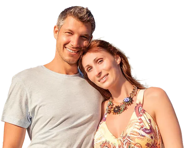 Smiling middle-aged couple standing together, representing wellness and healthy aging